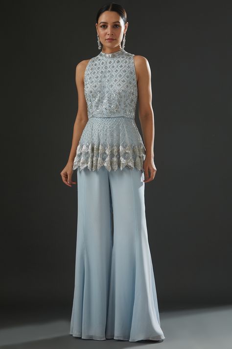 Featuring a powder blue peplum top in georgette and organza base with floral embroidery. It is paired with matching flared pants. . #perniaspopupshop #whatiworewastrending #ppuslove Indian Outfits Modern, Sharara Dress, Blue Peplum Top, Frock Designs, Bootcut Pants, Indian Fashion Designers, Frock Design, Pernia Pop Up Shop, Flared Pants