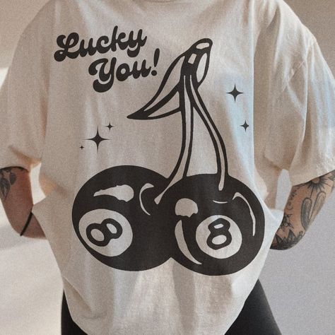 Lucky You Cherry 8 Ball Tee Embrace A Trendy Aesthetic With This "Lucky You" Cherry 8 Ball Tee. Material: Soft Cotton Fabric. Design: Features A Unique Graphic With Cherries And An 8 Ball, Perfect For St. Patrick’s Day And Beyond. Fit: Unisex, Relaxed Fit Suitable For All Body Types. Sizes: Xs To Xxl. Ideal For A Stylish And Lucky Look. Order Now And Celebrate In Comfort And Style! Cricut Shirt Ideas Women, Cherry 8 Ball, Women's Tshirt, Womens Graphic Tees, Trendy Items, Cream Shirt, Trendy Aesthetic, Trendy Graphic Tees, 8 Ball