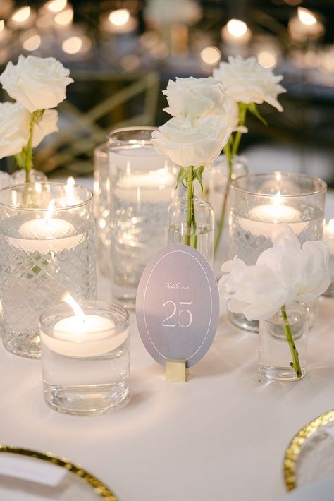 We used a combination of white roses and white peonies in clear glass bud vases with floating candles to create this simple but magical wedding table centerpiece! Floral by @florafetish | Photography by @honeygemc • • • white wedding floral centerpiece white floral centerpiece with candles floating candle centerpiece wedding bud vase centerpiece white bud vase floral centerpiece Bud Vase Wedding Centerpiece, Candle Centerpiece Wedding, Peonies Wedding Table, Peonies Wedding Centerpieces, Centerpiece With Candles, White Rose Centerpieces, Vase Candle Centerpiece, Bud Vases Wedding, Floating Candle Centerpieces Wedding