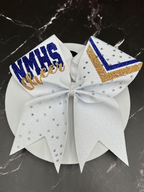 3" x 28" grosgrain ribbon with glitter heat transfer vinyl and ponytail elastic attached. Finished product 7" wide by 7" tall.  "Price per bow" All bows and masks are customizable: we can do it in your colors, with your team name/ mascot/logo/ Font in YOUR budget, Just message me for information on how to place your custom order.  Materials and fabrics can be substituted. We do not warranty hair elastics as they are n ot manufactured by us. All custom orders and bows with names/initials/monogram Cheer Bows With Names, Cheer Bow Ideas, White Cheer Bows, Competition Cheer Bows, Coachella Party Theme, Cute Cheer Bows, Competition Bows, Custom Cheer Bows, Coachella Party