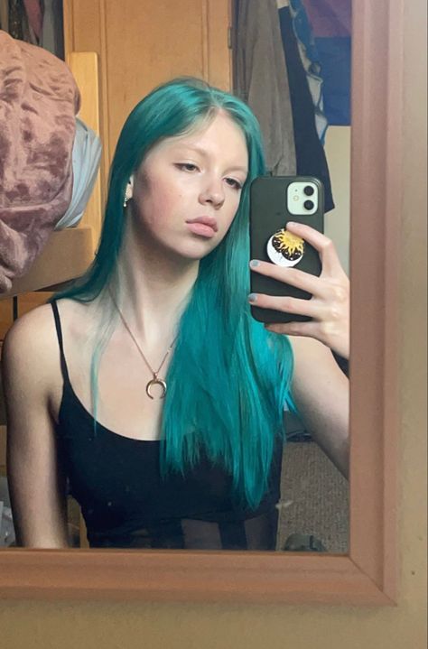 girl with bright blue hair in a black mesh tank top Blue Green Hair Color, Teal Hair Dye On Brown Hair, Teal Blue Hair, Teal Hair Aesthetic, Teal Roots Hair, Short Teal Hair, Teal Split Dye Hair, Blue And Green Dyed Hair, Teal Hair Dye