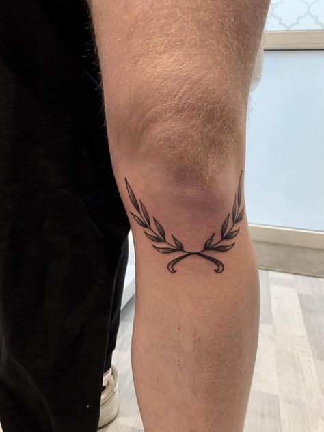 Leaf Knee Tattoo Men, Laurel Wreath Knee Tattoo, Above Knee Tattoo Men Words, Greek Leaves Tattoo Knee, Laurel Knee Tattoo, Wreath Knee Tattoo, Unisex Tattoo Ideas, Knee Wreath Tattoo, Olive Branch Knee Tattoo