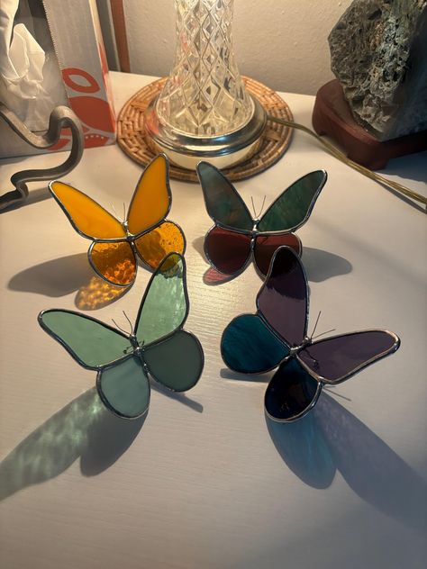 These gorgeous glass butterflies are handmade to order! Little legs are carefully soldered to allow these beautiful bugs to sit gracefully on any windowsill, shelf, desktop, table, or wherever you need a little pop of color.  Please reach out if specific glass is wanted! Otherwise, I will carefully select the glass that I think will look nicely together to complete your butterfly 🦋 Stained Glass Sculpture, Windowsill Shelf, Butterfly Stained Glass, Glass Butterflies, Diy Stained Glass Window, Stained Glass Night Lights, Butterfly Candles, Desktop Table, L'art Du Vitrail