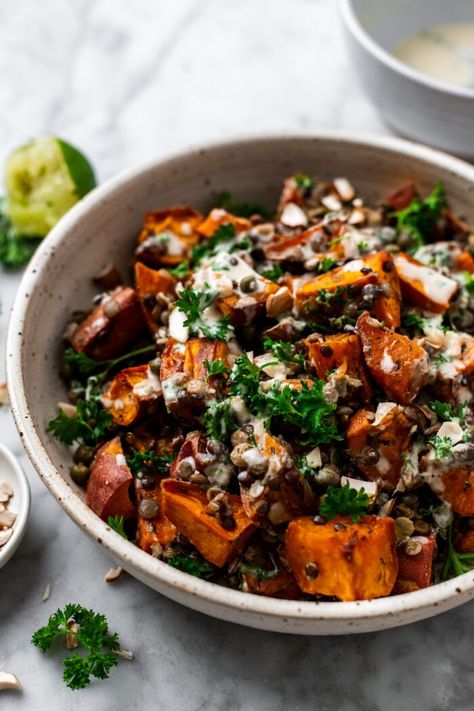 This warm roasted sweet potato lentil salad is a super simple quick sheet pan dinner tossed in a 2 minute roasted garlic tahini dressing, chopped almonds, and fresh parsley. A deliciously flavor-packed healthy meal or side dish that's full of plant protein and satiating fats to serve all week long! Brown Butter Lentil And Sweet Potato Salad, Potato Lentil Salad, Sweet Potato Tahini, Lentils Salad, Salad With Lentils, Mindful Meals, Roasted Sweet Potato Salad, Lentil Sweet Potato, Sweet Potato Salad