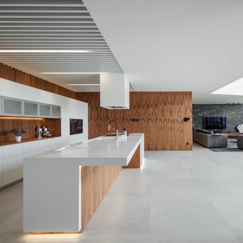 The kitchen is part of the open plan social area but is positioned outside of the double-height volume Grey Accent Wall, Braga Portugal, Concrete Houses, Concrete House, Small Hallways, Free Standing Bath Tub, Minimalist Kitchen, Luxury Kitchen, Kitchen Style