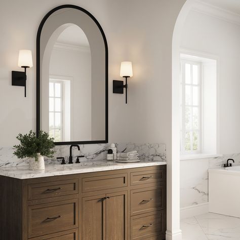 The Blake Vanity Collection references a classic silhouette paired with a modern, sleek finish in distinctive matte black. Versatile and stylish, this transitional wall sconce makes a wonderful addition to your primary bathroom vanity and adds sophistication to your powder room. Featuring a slim arm mounted to a square backplate, supporting a beautiful frosted glass shade, this 16” tall wall light provides soft illumination for your room. The Blake is also available in a coordinating 24" 3 light Bathroom Black Finishes, Matte Black Bathroom Accessories Decor, Bathroom Black Light Fixtures, Guest Bathroom With Black Fixtures, Black Fixtures In Bathroom, Best Lighting For Bathroom Vanity, Matte Black And White Bathroom, Neutral Moody Bathroom, Bathroom Mirror And Sconces