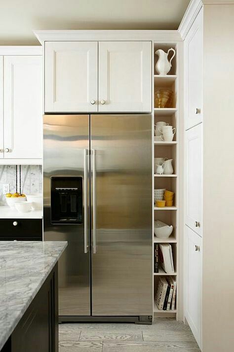 Open narrow shelves, cookbooks? White Upper Cabinets, Refrigerator Cabinet, Kitchen Fridges, Condo Kitchen, Stainless Steel Refrigerator, Kitchen Refrigerator, Kitchen Corner, Yellow Kitchen, Upper Cabinets