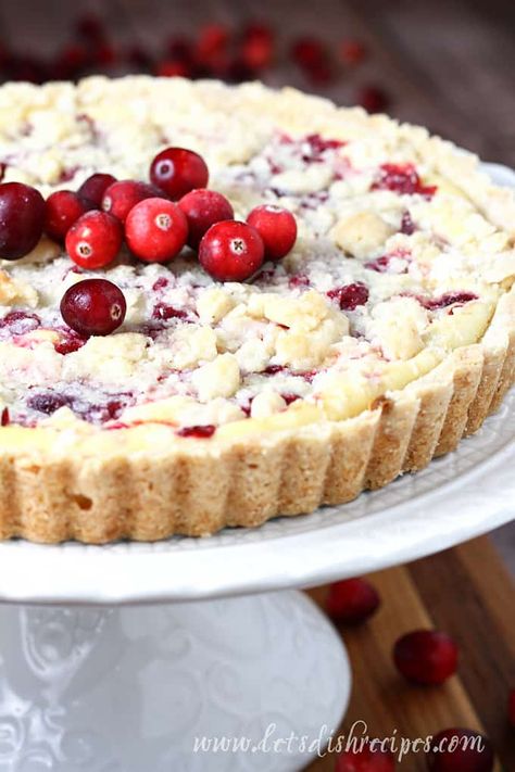 Cranberry Cheesecake Tart Recipe -- Sweetened cream cheese filling is swirled with tart cranberry sauce and baked in a shortbread crust in this easy but elegant dessert that's perfect for the holiday season. #cranberry #cheesecake #holidaybaking #christmas Christmas Tarts Desserts, Cranberry Orange Custard Pie, Cranberry Cream Cheese Tart, Christmas Tart Recipes, Cranberry Swirl Cheesecake, Shortbread Crust Desserts, Cranberry Cake Recipes, Cranberry Custard Tart, Orange Crumb Cake