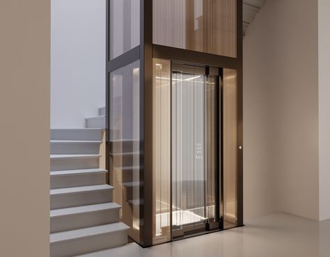 Stairs Lift Design, Stairs With Elevator Design, Stairs With Lift, Glass Elevator Design, Glass Elevator Design Interiors, Lift Design Interior, Hotel Lift Lobby, Lobby Residential, Lift Wall Cladding Design