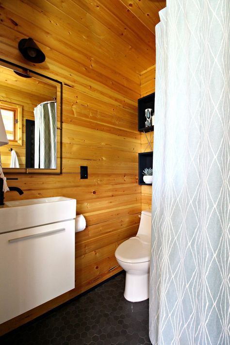 Modern Cabin Bunkie Bathroom Renovation with Charcoal Hex Tile, Matte Black Faucet and Fixtures, and lots of DIY Projects.  #moderncottage #moderncabin #cabin #lakehouse #cottageliving Pine Bathroom, Bathtub Designs, Diy Stock Tank, Cottage Bathroom Ideas, Scandinavian Cottage, Matte Black Faucet, Cabin Bathrooms, Pine Walls, Cottage Bathroom