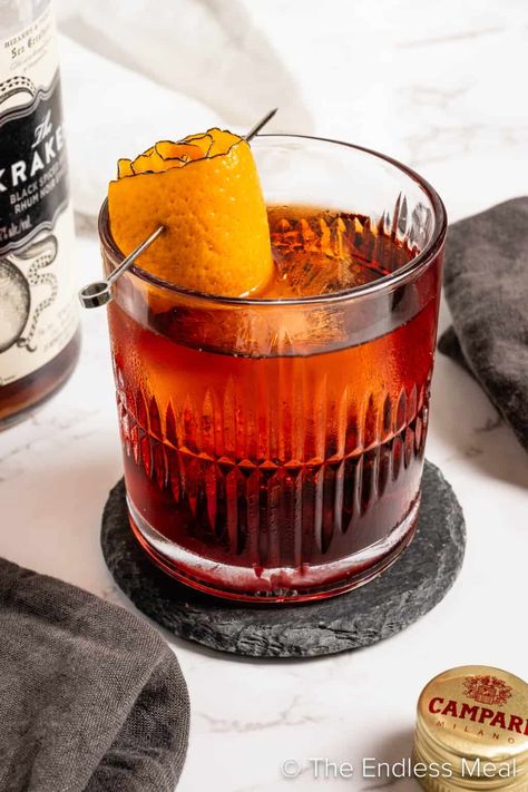 A rum negroni is a simple-to-make twist on the classic that is perfect for rum lovers. Dark, spiced rum pairs wonderfully with bitter Campari and sweet vermouth to make a cocktail you'll love sipping! #theendlessmeal #negroni #rum #rumnegroni #campari #cocktail #darkrum #spicedrum #drink Campari Cocktail, Dark Rum Cocktails, Spiced Rum Cocktails, Spiced Cocktail, Negroni Recipe, Sweet Vermouth, Rum Recipes, Batch Cocktails, Drink At Home