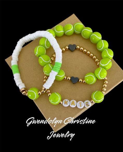 My tennis  Stretchy bracelets are fun and fashionable for the the proud tennis mama  or the tennis athlete.  Personalize your stack with your  name and number. Buy 1 bracelet or stack all 3.. bracelets will come as seen in picture unless you specify different colors at checkout in personalization section  My bracelets are custom made with very durable stretchy jewelry cording.  This listing is for 1  or all 3 bracelets made. Please indicate preference at checkout along with personalized information in personalization section ➡️ I can also make bracelets with silver beads as well just indicate that in the personalization section Also if you would like custom colors send me a message and I will do my best to accommodate you!  otherwise, bracelet will come in the white and green  ❤️Sizing det Tennis Bracelet Ideas, Diy Tennis Bracelet, Tennis Craft Ideas, Tennis Senior Night, Tennis Wristband, Tennis Athlete, Tennis Gift Ideas, Tennis Crafts, Tennis Lifestyle