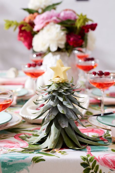 It’s summer, and we love summer! But for a little fun (and to make the sunny season even brighter), why not add a splash of wintry whimsy to your summer wonderland? In celebration of being more than halfway to the holidays, we’re setting the scene with two Christmas in July party themes. Both party themes include a DIY project to try and a “cup of cheer” drink recipe to get you in the spirit of the seasons—summer and winter together. Read on and get your ho-ho-hos while it’s hot-hot-hot! Tropical Christmas Party Decorations, Tropical Holiday Decor, Summer In Winter Party Theme, Christmas Luau Decorations, Christmas Tiki Party, Tropical Holiday Party, Hawaiian Christmas Dinner, Summer Christmas Decor, Christmas In July Bridal Shower Ideas