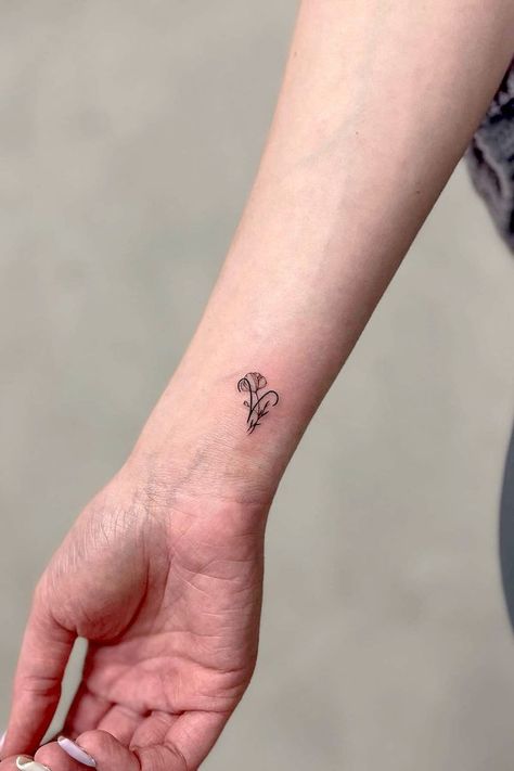 30 Aries Tattoo Ideas & Designs Daisy And Aries Tattoo, Aries Tattoo Behind The Ear, Aries Neck Tattoos Women, Minimal Aries Tattoo, Fire Aries Tattoo, Aries Tiny Tattoo, Tattoos For Aries Women, Aries Aquarius Tattoo, Aries Wrist Tattoo