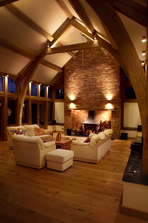 Surface mounted spotlights provide direct lighting to the central area of this living room.  The same design provides a peripheral light by reflecting back from the oak frame.  Up and down lighting on the chimney breast highlights the texture of the bricks. Barn House Conversion, Barn Conversion Interiors, Vaulted Ceiling Ideas, Oak Framed Extensions, Vaulted Ceiling Lighting, Scandinavian Design Living Room, Down Lighting, Barn Living, Coastal Dining