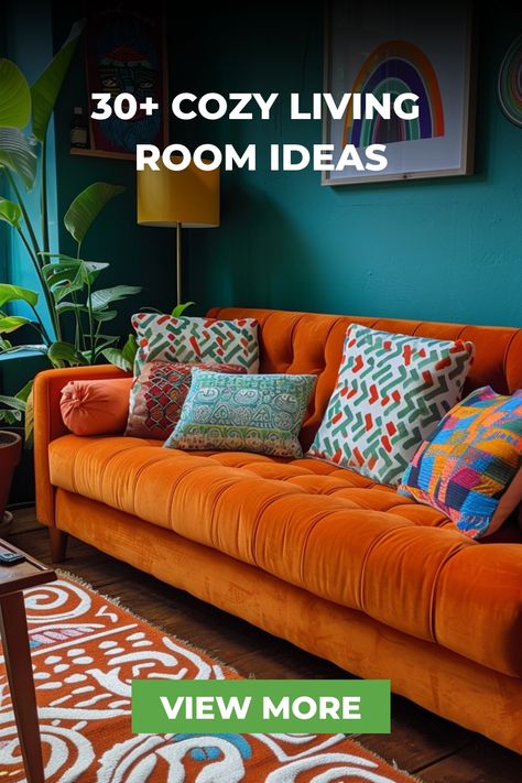 This eclectic living room showcases a bright orange sofa with colorful patterned pillows, set against teal walls. Unique artwork and a mix of textures create a vibrant and cozy space. Contrast Sofas Living Room, Orange Sofas Living Room, Mix Sofas Living Rooms, Comfy Tv Room, Bright Living Room Colors, Turquoise Couch Living Room Ideas, Living Room With Orange Couch, Orange Sofa Design, Teal Sofa Living Room Decor