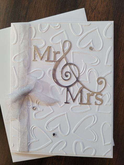 "Handmade wedding greeting card - size 5.5\"x4.25\".  Card base is heavy white card stock layered with white dry embossed with hearts layer, die cut silver Mr & Mrs.  Embellished with sparkly silver ribbon/bow and sparkly gems.  Inside sentiment is \"Wishing you a happily ever after\" stamped in gray ink.  Includes a white envelope." Silver Wedding Card, Home Made Wedding Cards, Wedding Cards Handmade Simple, Handmade Wedding Cards, Homemade Wedding Cards, Silver Wedding Cards, Wedding Challenge, Wedding Card Craft, Greeting Cards Handmade Birthday