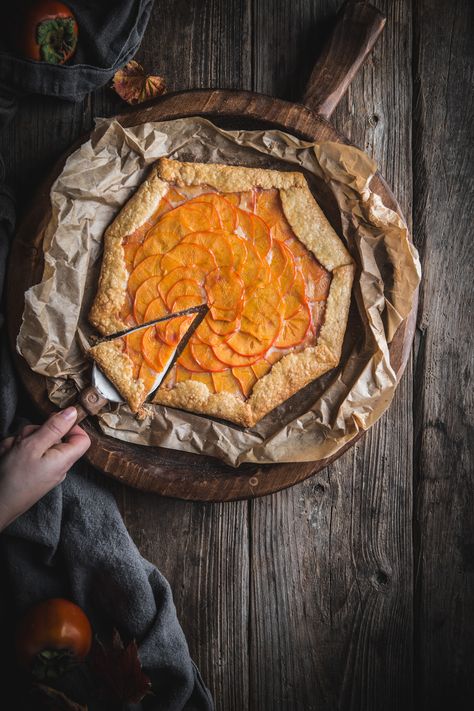 Persimmon Galette with Mascarpone Filling by Eva Kosmas Flores   This persimmon galette contains layers of persimmons soaked in a cinnamon syrup, with a vanilla mascarpone filling underneath, wrapped in a flakey crust. #persimmon #galette #mascarpone #cinnamon #vanilla #adventuresincooking #dessert Persimmon Galette, Persimmon Dessert, Enchanted Kitchen, Persimmon Bread, Family Dessert Recipes, Dessert Fall, Mascarpone Filling, Rustic Food Photography, Mascarpone Dessert