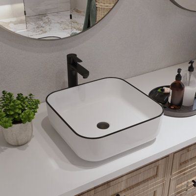 The vessel sink is made from strong ceramic construction, which has a good performance in daily use. The stain-resistant and dust-resistant material can effectively reduce bacterial residue and keep sanitary of the inside sink. Designed with a white surface and black edge, the simplistic and stylish style will add more exquisiteness to the outward appearance of the vessel sink and make your bathroom look more beautiful. What's more, the above counter installation design can save more time and ef White Vessel Sink On Black Countertop, Sink Bowl On Top Of Vanity, Vessel Sink Ideas, White Vessel Sink, Rectangular Vessel Sink, Bathroom Sink Design, Rectangular Sink Bathroom, Compact Bathroom, Square Ceramic