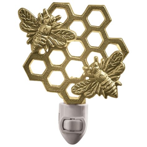 Beautiful buzzing bees gleam with the honeycomb design in a glorious golden finish for a chic display that delightfully illuminates a room space with a sense of nature. Place this decorative plug-in light in a variety of interior styles and room choices like a hallway, bedroom, entryway or bathroom space. Simply position within the desired outlet and flip the manual switch to activate a comfortable lighting accent within your spring farmhouse or summer home decor. A 5-Watt bulb is included, prov Seasonal Room Decor, Bathroom Night Light, Bee Nursery, Entryway Stairs, Seasonal Room, New Homeowner Gift, Busy Bees, Honeycomb Design, Night Light Lamp