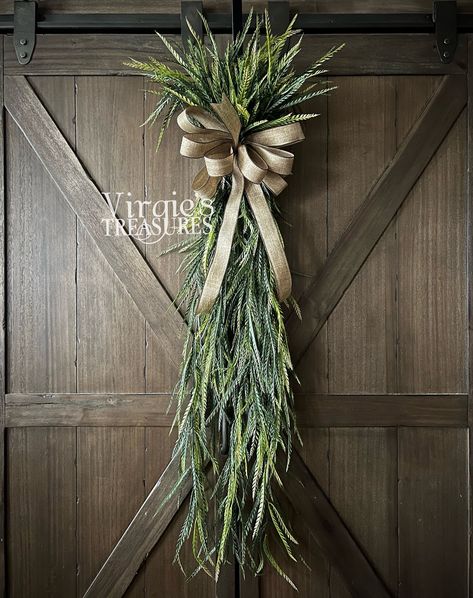 "Add a touch of color and fullness to your door with this Saw Grass Swag. This swag features luscious, soft, plastic greenery. Finished with a faux burlap bow. Length: 43\" Width: 9\" Loop on the back to hang.  Add it to a wall or door in your living room, bedroom, or kitchen! Dress up your door anywhere in your home with this beautiful everyday wreath.  Visit www.facebook.com/virgiestreasures to see many more! Don't forget to like us on Facebook! All sales are final.  See shop policies." Extra Thick Grapevine Wreath, Spring Door Swag, Pampas Grass Swag, Fall Swags For Front Door, Christmas Swags Ideas, Modern Wreaths, Greenery Swag, Spring Swag, Front Door Swag