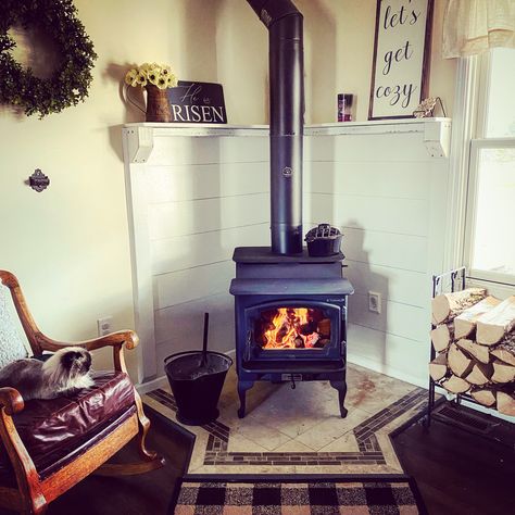 Lopi endeavor corner wood stove with ship lap mantle Corner Wood Stove Mantle, Wood Stove Styling, Corner Fireplace With Woodstove, Wood Stove Corner Ideas, Tiny House Fireplace Wood Burning Stoves, Corner Wood Stove Ideas, Tiny House Wood Stove Hearth, Corner Mantle, Pellet Stove Hearth