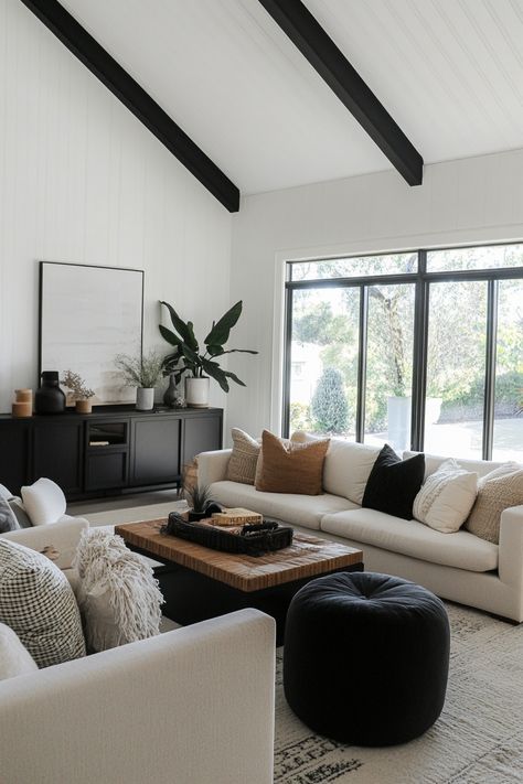 Black and beige living rooms offer a timeless, sophisticated look. These colors, when combined thoughtfully, create a perfect balance of warmth and elegance. Get inspired by these 20 stunning black and beige living room ideas, perfect for creating a space that exudes both comfort and refinement. Black And Tan House Decor, Living Room With Black Window Frames, Gray Black Beige Color Palette, Wood Black White Living Room, Black Modern Boho Living Room, Modern Cozy Living Room Apartment, Modern Day Living Room Ideas, White And Black With Wood Accents, Black White Oak Living Room