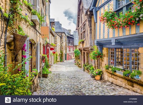 Beautiful view of scenic narrow alley with historic traditional houses and cobbled street in an old town in Europe with blue sky and clouds in summer  Stock Photo Western Region, Visit France, Studio Props, Beaux Villages, Medieval Town, Old City, Background For Photography, Lonely Planet, Claude Monet