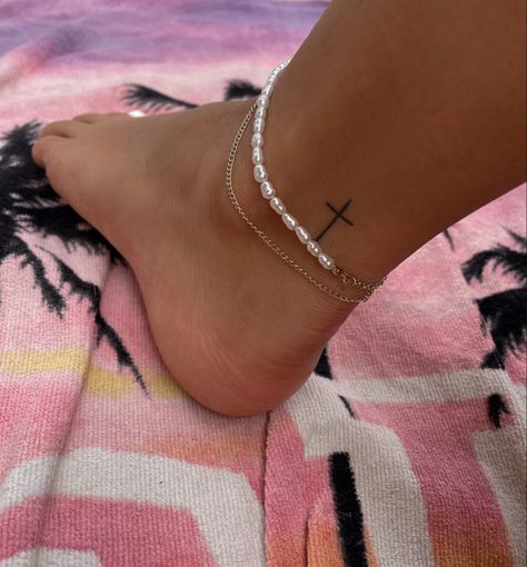 Tattoo | tattoo ideas by  Norman Aguilera Cute Tattoos Ankle, Ankle Tattoo Aesthetic, Cross Foot Tattoo, White Ink Cross Tattoo, Little Cute Tattoos For Women, Tiny Cross Tattoos For Women, Cross Tattoos For Women Ankle, Cute Small Ankle Tattoos, Hidden Tattoos Black Women