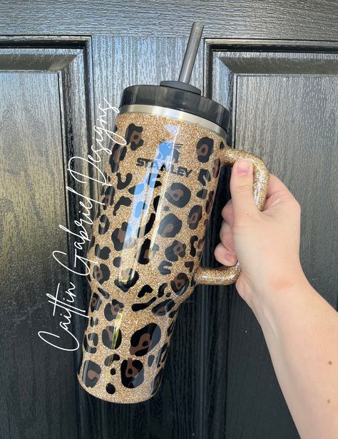 "TikTok Leopard Print Tumbler  If you are wanting the cup in the LISTING PHOTO you MUST select the option \"Stanley 40 oz\" from the drop-down. I offer multiple cup styles with this design. If you have any questions feel free to reach out!  Unless otherwise requested Stanley and Simple Modern tumblers will be made using a black base cup.  The tumbler is sealed with epoxy to give a glass-like finish.  CARE INSTRUCTIONS: -HAND WASH ONLY -DO NOT MICROWAVE -DO NOT SOAK -NOT DISHWASHER SAFE -AVOID EX Cheetah Print Tumbler Cups, Cheetah Print Stanley Cup, Resin Stanley Cup, Leopard Print Stanley Cup, Leopard Stanley Cup, Stanley Customized, Personalized Tumbler Ideas, Epoxy Stanley Cup, Yeti Cups