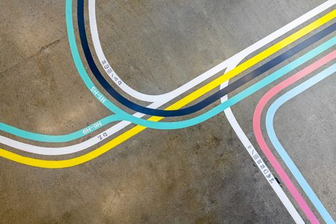 Inspired by street signage and transportation infrastructure, Rapt Studio designed a wayfinding system with bold stripes of color for DoorDash’s headquarters office. Floor Wayfinding, Floor Signage, Floor Graphics, Wayfinding Design, Wayfinding System, Painted Floor, Modern Office Design, Contemporary Office, Collaboration Space