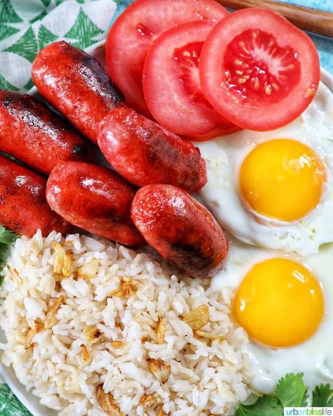 Longsilog is a traditional Filipino big breakfast that's made with longanisa (Filipino sweet sausage), Sinangag (Filipino garlic rice), and fried eggs. Get the recipe at UrbanBlissLife.com. Filipino Sausage, Longsilog, Silog Meals, Garlic Rice Recipes, Curried Sausages, Filipino Breakfast, Fried Garlic, Runny Eggs, Garlic Rice