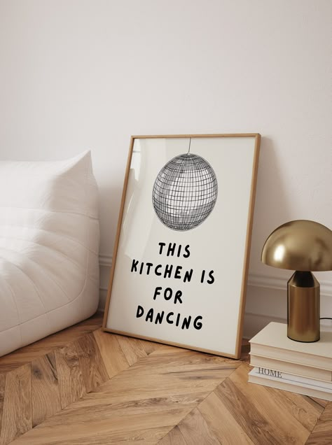 Add a playful touch to your kitchen decor with this trendy "Kitchen is for Dancing" poster. Featuring a whimsical disco ball illustration and the fun text "This kitchen is for dancing," this high-quality art print brings a lively and cheerful vibe to any cooking space. Perfect for those who love to dance while they cook, this poster serves as a joyful reminder to enjoy every moment in the kitchen. Its vibrant and engaging design makes it an excellent addition to your wall, creating an inviting and energetic atmosphere. This unique kitchen wall art also makes a fantastic gift for friends and family who share a love for food and dancing. Kitchen is for Dancing Poster, Trendy Kitchen Print, Cool Cute Cooking Kitchen Art Print, Kitchen Wall Poster, High Quality Print, Disco Ball Kitchen Poster Disco Ball Illustration, Kitchen Wall Prints, Cute Cooking, Fun Kitchen Decor, Ball Illustration, Kitchen Is For Dancing, Dancing In The Kitchen, Poster High Quality, Dance Poster