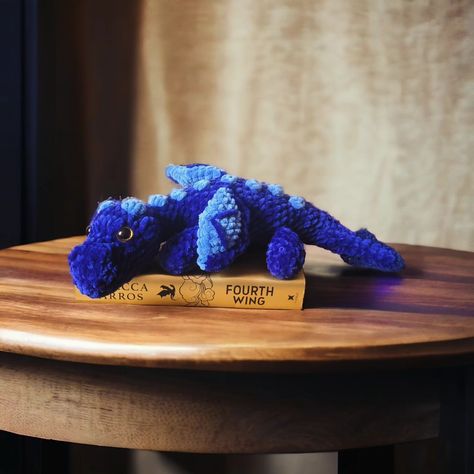 Sgaeyl! 🐉 💙 Crocheted another dragon because, let's face it, I can't get enough! Meet Sgaeyl from Fourth Wing, joining Tairn and Andarna. Took a stab at making her daggertail, too, of course. 🗡️ Now, onto the next dragon..... Feirge, Deigh, Aotrom, or Sliseag? 🤔 Decisions, decisions! Amazing no-sew dragon pattern by @crochetbygenna #dragon #fourthwing #ironflame #onyxstorm #rebeccayarros #obessed Fourth Wing Crochet, Wing Crochet, Decisions Decisions, Fourth Wing, Dragon Pattern, Crochet Stuff, Fiber Art, Crochet Projects, The Next