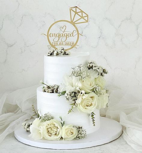 Get inspired by our collection of over 50 elegant engagement cake ideas to celebrate your love - from simple, to floral or abstract, these cakes are the perfect addition to your engagement party! Looking for simple yet stunning engagement cake ideas? From elegant to creative simple designs, we have your inspiration. Save to "Simplistic Elegance" and see our article for more ideas. Cake Decorating For Engagement, Engagement Cake Designs Couple, Simple Engagement Cake Designs Unique, Ring Cake Engagement, Engagement Cakes Elegant, Engagement Cakes Simple, Cake Design For Engagement, Cakes For Engagement Couple, Engagement Cake Designs Classy