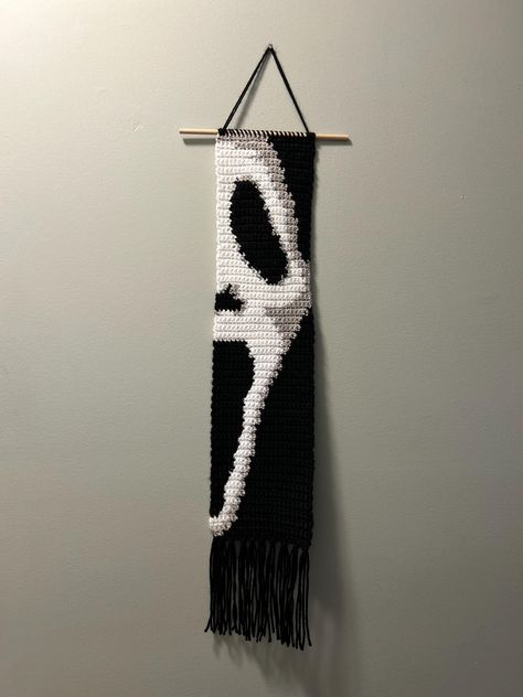 This is a finished item, not a pattern.  Halloween ghost crochet wall hanging.  Perfect for any Halloween movie lover.  The measurements are: -21in long not including the fringe  -26in long including fringe  -30.5in long from hook to fringe  -5.25in wide This wall hanging is made with acrylic yarn and has a wooden dowel rod. It is very lightweight and can hang from a nail, push pin, or anything you want to hang it from. Diy Tapestry Wall Hanging, Ghost Face Crochet Pattern, Halloween Crochet Tapestry, Ghost Face Crochet, Crochet Seasonal, Spooky Crochet, Ghost Crochet, Macrame Crafts, Crochet Wall Hanging