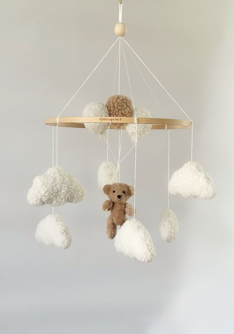 Mobile Teddy Bear boucle Clouds Boucle Neutral gender mobile Nursery decor boucle Pregnancy gift Clouds mobile Brown bear mobile A minimalist bouclé mobile with clouds and bear with balloon is an ideal decor for a child's room for both a boy and a girl! For a child's room in any style! Made with love! 💭Materials: Korean felt American felt Hypoallergenic filler Beech wood base Boucle  💭TO ORDER If you would like to make a custom order, just message me! You can change the details of any children Teddy Bear Mobile, Teddy Bear Nursery Theme, Bear Themed Nursery, Bear Nursery Theme, Clouds Mobile, Teddy Bear With Balloons, Bear With Balloons, Bear Mobile, Teddy Bear Nursery