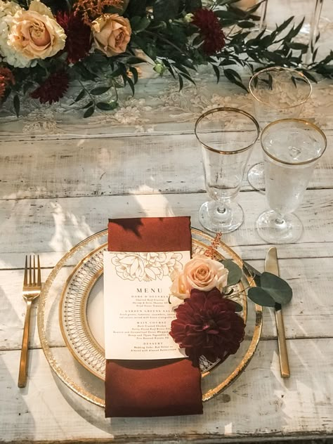 Burgundy gold and white wedding reception decoration Burgundy And Terracotta Wedding Table, Terracotta Burgundy Gold Wedding, Burnt Orange Wedding Place Setting, Terracotta And Gold Wedding Decor, Gold Rimmed Plate Table Setting, Terrocata And Burgundy Wedding, Gold Fall Wedding Decor, Fall Wedding With Gold Accents, Bride And Groom Table Burgundy