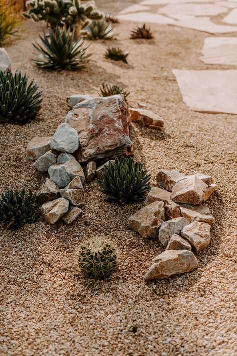 These clients had a few beautiful specimens that begged to be displayed. We added an eclectic mix of cacti and succulents, a neutral rock finish material to let the plants shine, and some interesting boulders to complete this effortlessly cool cactus garden. The final touch was a flagstone pathway and seating area to draw guests into the space. If you're looking for a yard idea that's as low maintenance as it is unforgettable, this is it! Stone And Gravel Pathway, Sandstone Rock Garden, Rock Ideas Landscaping, Front Yard Design With Rocks, Backyard Desert Landscape Ideas, Cactus Rock Garden, Landscaping Pebbles, Desert Plants Landscaping, Cool Cactus