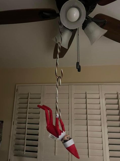 Elf On The Shelf Walking On The Ceiling, Elf On Ceiling Fan, Elf Hanging From Candy Canes, Elf Hanging From Ceiling, Elf On The Shelf Hanging From Light, Elf On The Shelf Ceiling Fan Ideas, Elf On The Shelf Hanging From Fan, Elf On The Shelf Ideas Ceiling Fan, Elf Hanging From Ceiling Fan