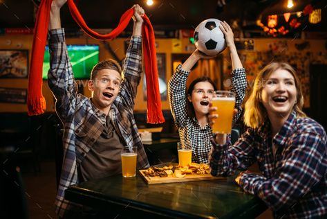 Football fans with scarf and ball in sports bar by NomadSoul1. Football fans with scarf and ball in hands watching match and drinks beer in sports bar. Tv broadcasting, young frien... #Affiliate #bar, #sports, #hands, #fans Tv Broadcasting, Bar Tv, Sports Pub, Friends Drinks, Watch Football, Watch Photo, Sports Bar, Football Games, Drinking Beer