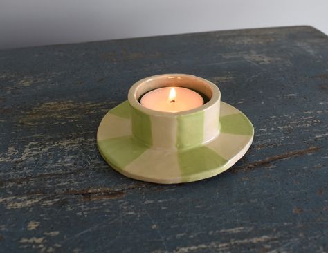 A hand sculpted ceramic tea light candle holder with a aqua blue interior and a candy green striped exterior. Handbuilding Pottery Ideas Candle Holders, Pottery Votive Candle Holders, Home Made Candle Holders, Diy Tea Candle Holders, Handbuilt Candle Holders, Homemade Clay Candle Holders, Ceramic Tea Candle Holders, Tea Light Ceramic, Clay Tea Candle Holders