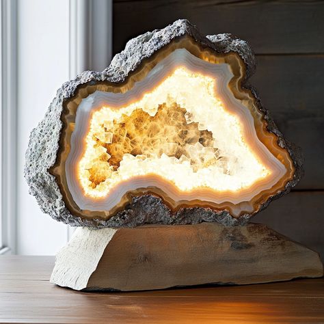 The Geode Lamp is a stunning fusion of nature and light, inspired by the raw beauty of geodes. This unique lamp features a crystal-like structure with a textured, mineral exterior and a radiant, glowing core. When illuminated, the lamp casts a mesmerizing, soft light that enhances any space with a touch of natural elegance. Perfect as a statement piece, the Geode Lamp brings the enchanting allure of the earth’s hidden treasures into your home. Geode Lamp, Unique Lamp, Raw Beauty, Unique Lamps, Hidden Treasures, Of The Earth, Soft Light, Soft Lighting, The Earth