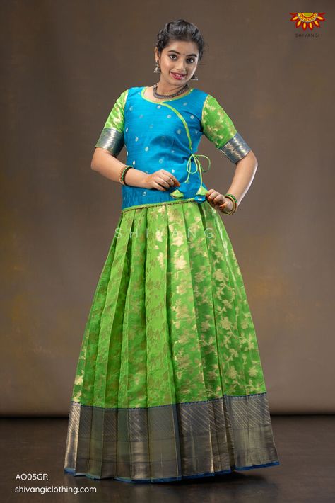 Grapevine Pattu Pavadai | Lehenga !!! Knife pleated skirt highlighted with floral jangla pattern paired with angrakha blouse. A perfect traditional yet trendy Pattupavadai for any special occasion. Click to buy : https://bit.ly/30SZvMv Whatsapp : 8098833000 #Shivangiclothing #newcollection #festiveseason #pattupavadai #ethnic #lehenga #kidsfashion #shoponline #instafashion #shopnow #diwalicollection #coimbatore #girlswear Pattu Pavadai Designs For Adults, Pattu Skirt And Blouse, Saree To Pattu Pavadai, Simple Pattu Pavadai Designs, Latest Pattu Pavadai Designs, Pattu Pavadai Designs Women, Pattu Langa Blouse Designs, Pattu Pavada Women, Lehengas Blouse