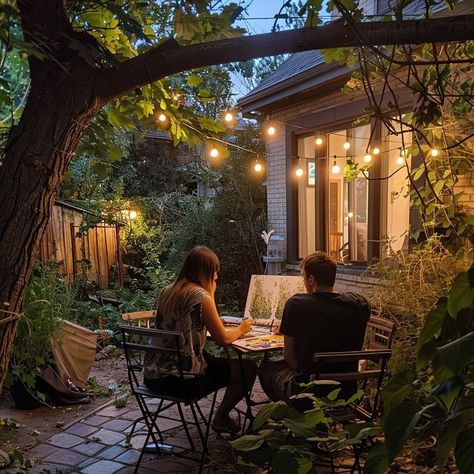 Couple having a romantic dinner in a garden at twilight, illuminated by string lights, surrounded by lush greenery. Perfect setting for a summer evening date. Outdoor Dinner Date, Romantic Outdoor Dinner, Twilight Garden, Outdoor Dinner, Date Dinner, Dinner Date, Summer Evening, Perfect Summer, String Lights