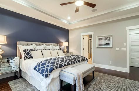 Master bedroom with light gray walls and dark blue accent wall behind tufted bed Blue Accent Wall, Blue Accent Walls, Accent Wall Colors, Light Grey Walls, Dekorasi Kamar Tidur, Accent Wall Bedroom, Blue Accent, Gray Bedroom, Blue Bedroom