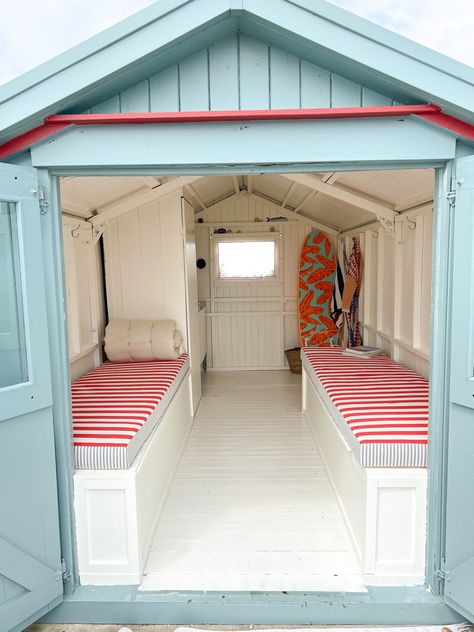 Our beautiful beach hut on the sussex coast in shoreham-by-sea, just outside of Brighton and Hove. Interior painted to match Farrow & Ball’s pointing with upholstery by a local upholsterer. Kids surf boards stacked in the back corner and a cabin small kitchen. Exterior painted in Incarnadine and oval room blue - so emmulate a swedish barn. Views of the ocean and a perfect shack to relax Beach Sheds, Beach Huts, Beach Shack Cubby House, Beach Hut Ideas, Beach Hut Shed Ideas, Beach Shack Interior, Small Chalet, Sheds Painted Like Beach Huts, Beach Hut Interior