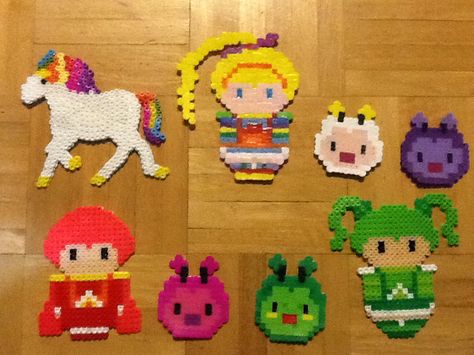 Rainbow Brite perler beads. RainbowBrite, Twink, Twillight, Starlite, I.Q, Red Butler, Patty O Green, Lucky. #perlerbead #rainbowbrite #twink #twillight #starlite #I.Q #redbutler #pattyogreen #lucky #80's Kidcore Perler Bead Patterns, Cartoon Perler Beads, Perler Bead Rugrats, Rainbow Mushroom Perler Beads, Rainbow Brite Pixel Art, Perler Ornaments, Tamagotchi Perler Beads, Christmas Shoes Diy, Diy Kandi Bracelets