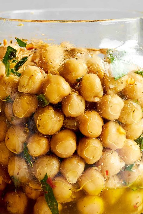 Prepare this marinated chickpeas recipe with simple ingredients, and keep it on hand to add flavor to salads, soups, and more! Food Dolls Marinated Chickpeas, Chickpeas In Salad, Marinated Garbanzo Beans, Marinated Chickpeas Recipe, Marinated Chickpea Salad, Pickled Chickpeas, Cumin Chickpeas, Marinated Beans, Marinated Chickpeas