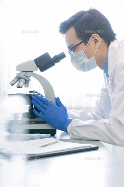 Professional Pharmacologist Using Microscope by Pressmaster. Vertical side view portrait of young male pharmacologist examining specimen chemical reaction using microscope in mod... #AD #side, #Vertical, #portrait, #view Side View Portrait, Daycare Menu, Chemical Reaction, Chemical Reactions, Side View, Dream Life, Vision Board, Siding, Quick Saves